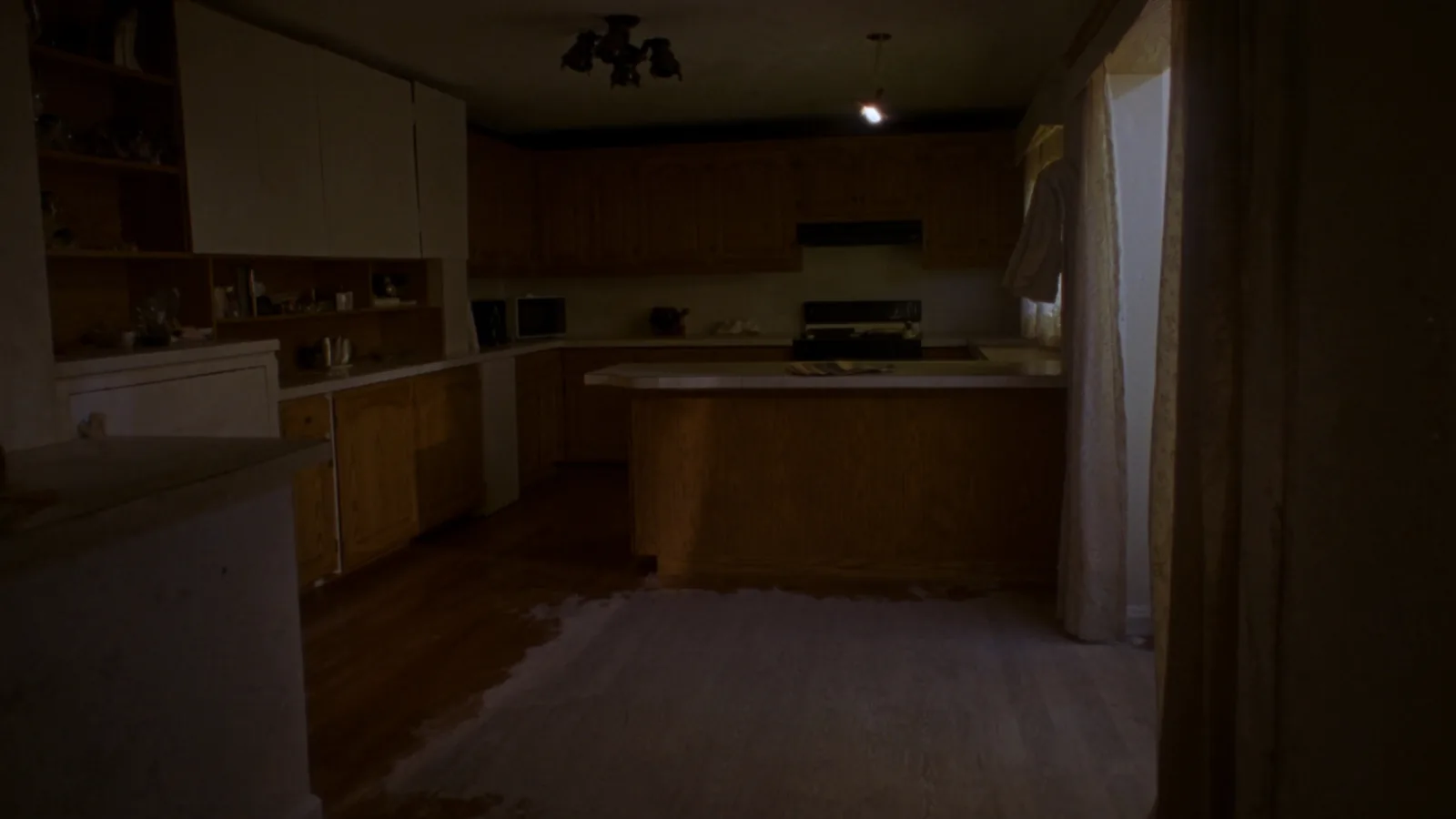 Cramped 1990s Tacoma kitchen before renovation — honey-oak cabinets and dated tile counters